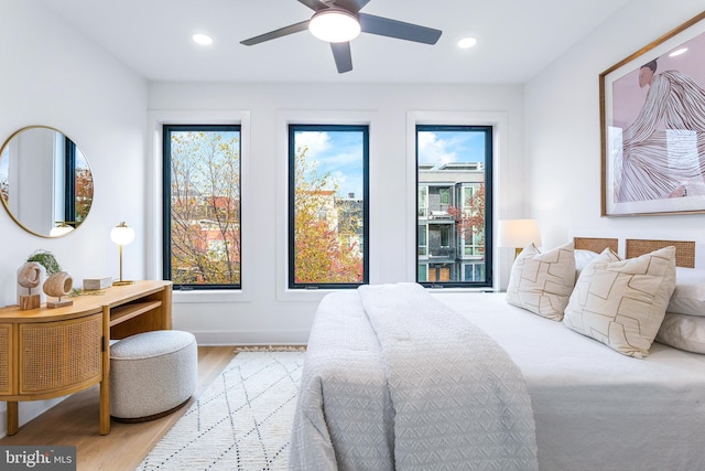 bedroom featuring recessed lighting, wood finished floors, baseboards, and ceiling fan