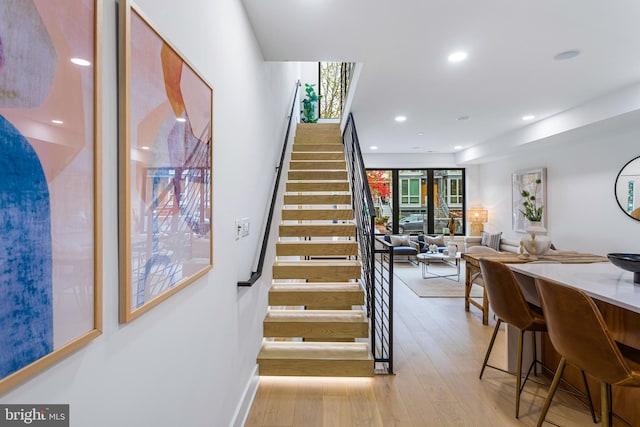 staircase with recessed lighting, baseboards, and hardwood / wood-style flooring