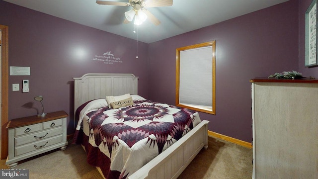 carpeted bedroom featuring a ceiling fan and baseboards