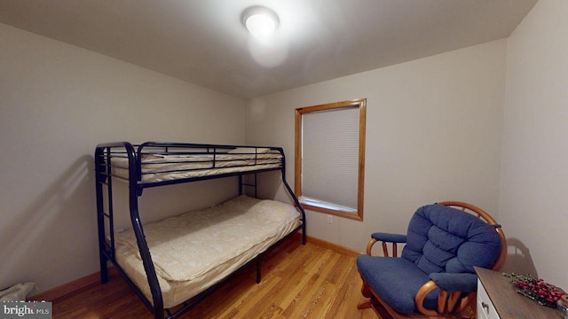 bedroom with wood finished floors and baseboards