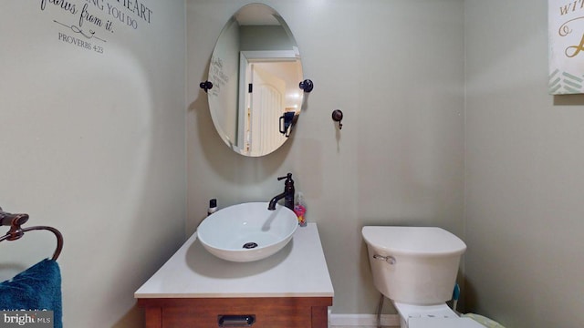 bathroom featuring toilet and vanity