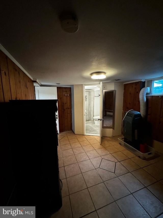 kitchen featuring light tile patterned flooring and ornamental molding