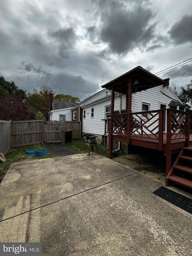 exterior space with a gate, a deck, and fence