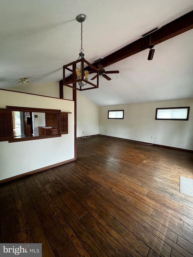 unfurnished living room featuring visible vents, ceiling fan with notable chandelier, lofted ceiling with beams, dark wood-style floors, and baseboards