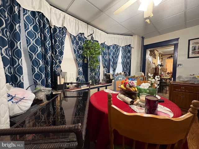 dining room featuring a drop ceiling and ceiling fan