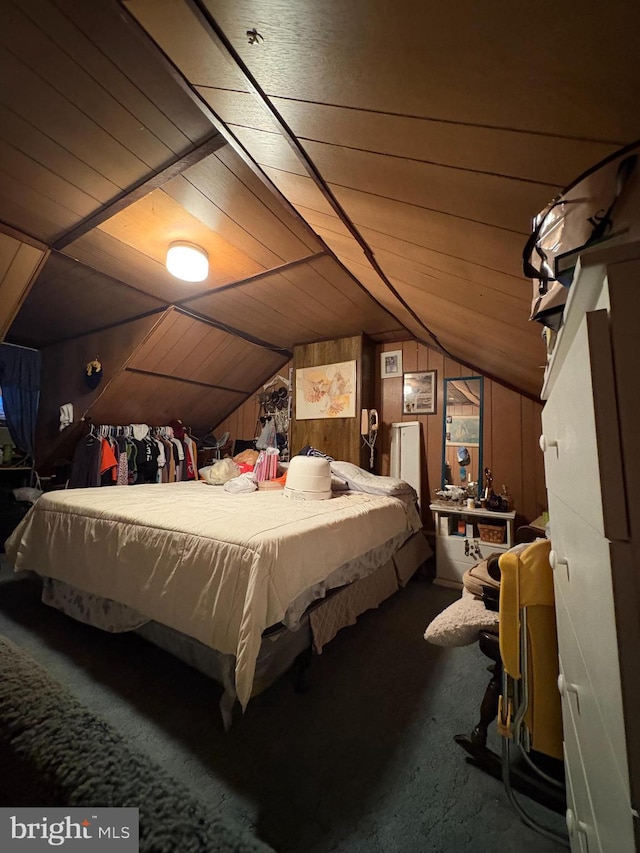 bedroom featuring vaulted ceiling, wooden walls, and wooden ceiling