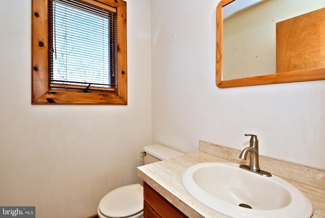 half bath featuring toilet and vanity