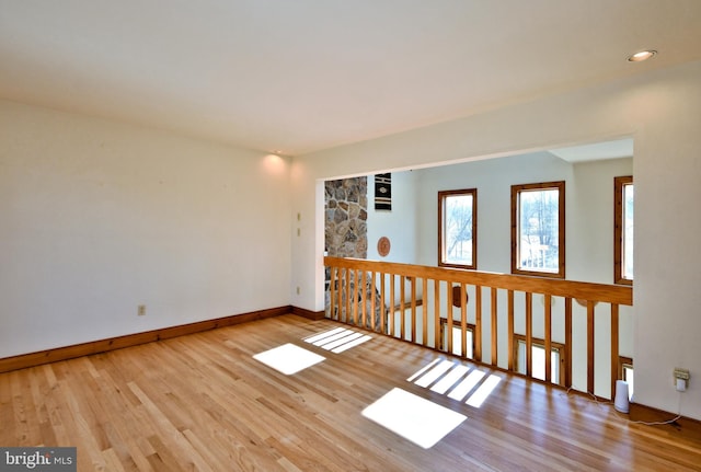 unfurnished room featuring baseboards and wood finished floors