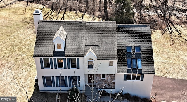 exterior space with roof with shingles and stucco siding