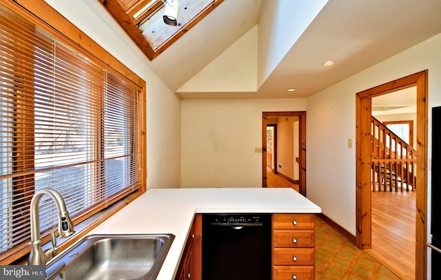 kitchen featuring brown cabinets, a sink, light countertops, light floors, and dishwasher