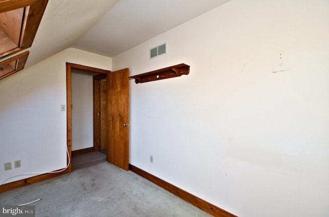 additional living space with lofted ceiling, carpet flooring, baseboards, and visible vents