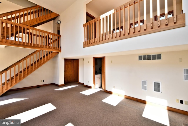 unfurnished living room featuring stairs, baseboards, visible vents, and carpet floors