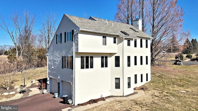 view of property exterior featuring driveway, an attached garage, a shingled roof, stucco siding, and a chimney