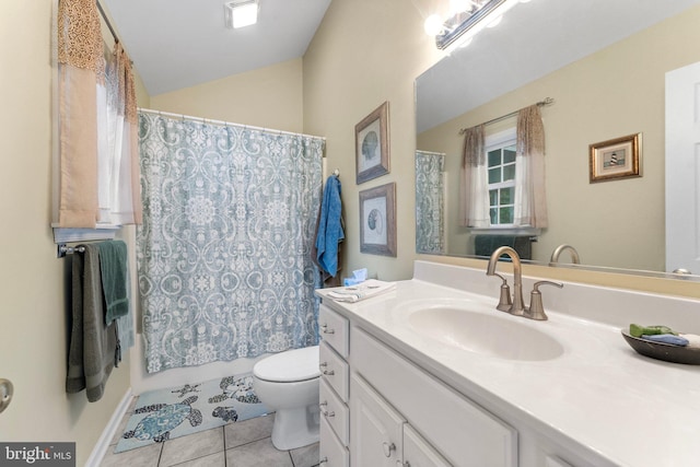 bathroom featuring tile patterned flooring, lofted ceiling, toilet, and vanity