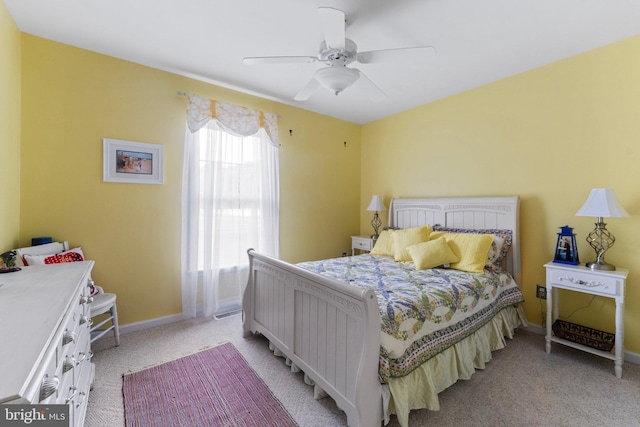 bedroom with baseboards, light carpet, and a ceiling fan