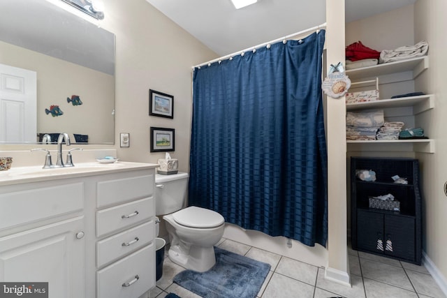 bathroom featuring tile patterned flooring, toilet, and vanity