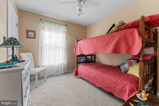 bedroom featuring visible vents, light colored carpet, and ceiling fan