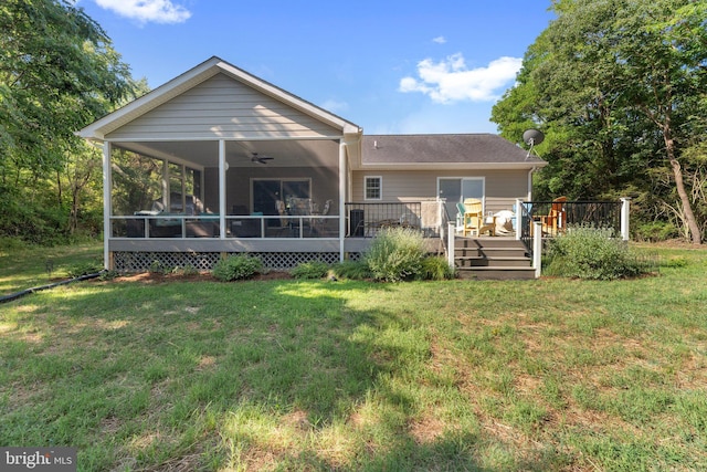 back of house with a yard, a wooden deck, a ceiling fan, and a sunroom