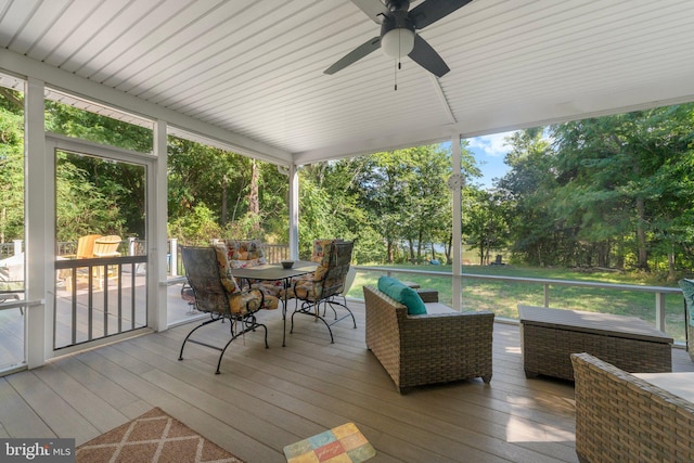 sunroom / solarium featuring ceiling fan