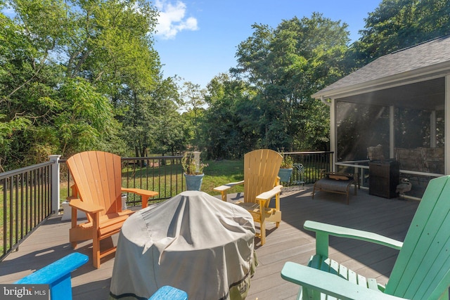 deck with a grill and a sunroom