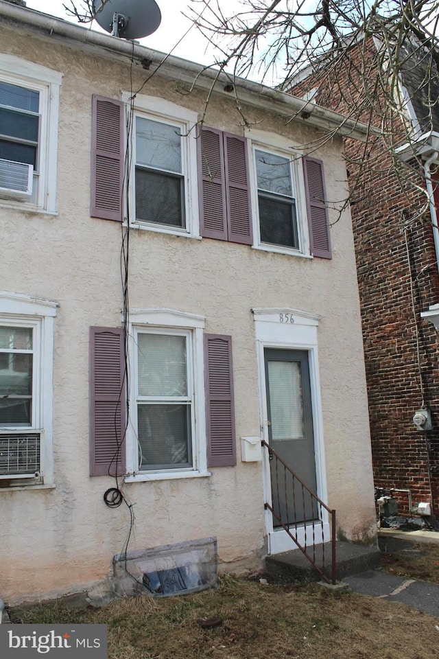 view of property featuring entry steps and stucco siding