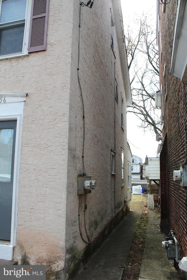 view of side of home with stucco siding