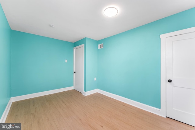 interior space with baseboards, visible vents, and light wood finished floors