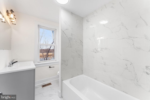 bathroom featuring visible vents, baseboards, toilet, marble finish floor, and vanity