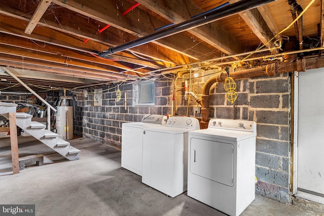 unfinished basement featuring stairway, independent washer and dryer, and water heater