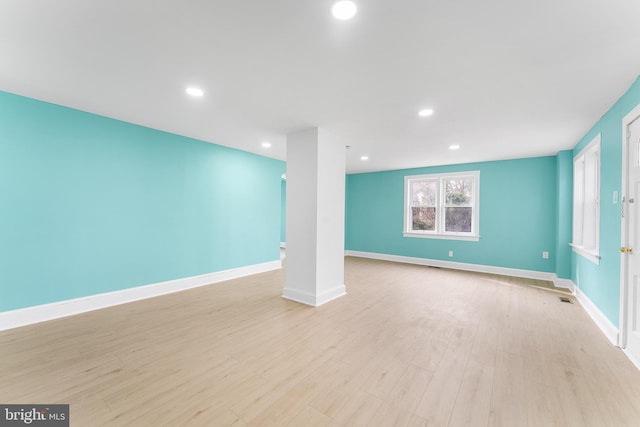 below grade area with visible vents, recessed lighting, baseboards, and light wood-type flooring