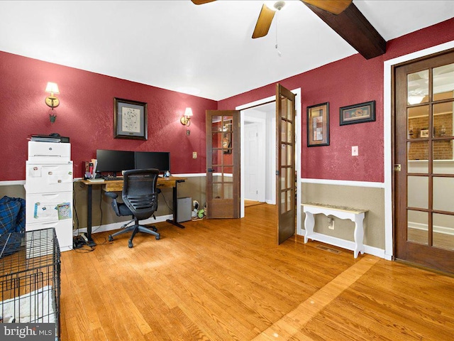 office featuring french doors, beamed ceiling, wood finished floors, and visible vents