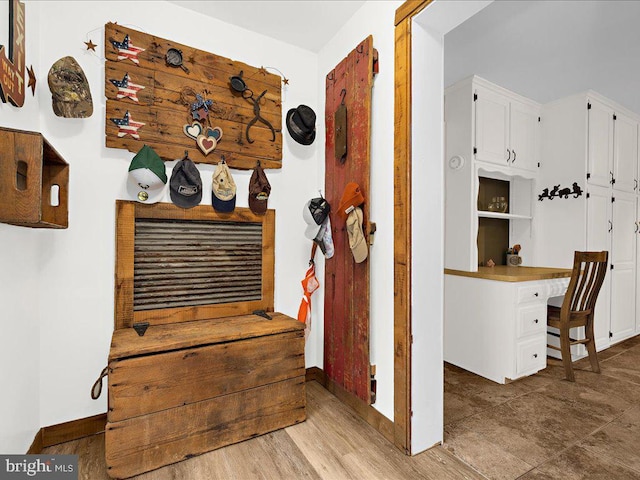 interior details featuring wood finished floors and baseboards