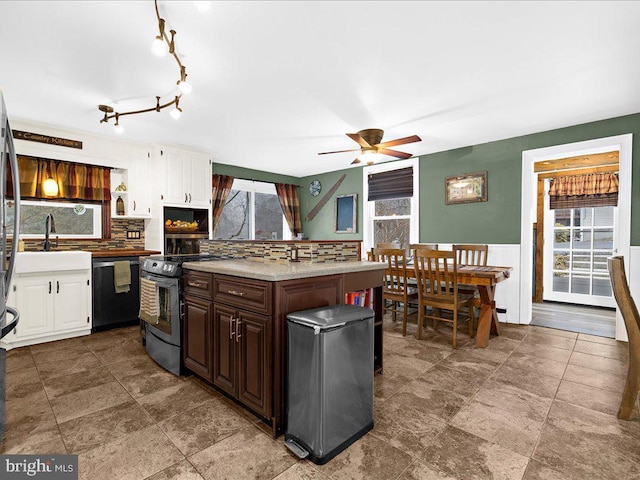 kitchen with stainless steel range with electric cooktop, white cabinetry, dishwasher, and a sink