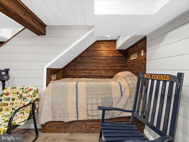 stairs with wooden walls and beamed ceiling