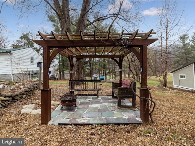 view of yard with a patio, a pergola, and an outdoor fire pit