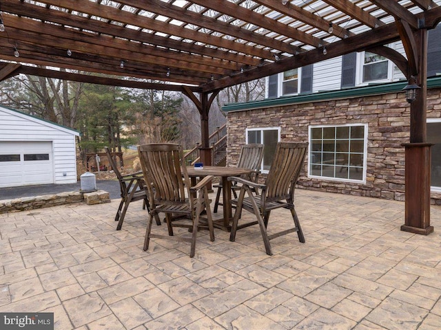 view of patio / terrace with outdoor dining area, an outdoor structure, and a pergola