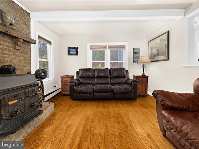 living room with light wood-type flooring, baseboards, and a baseboard heating unit