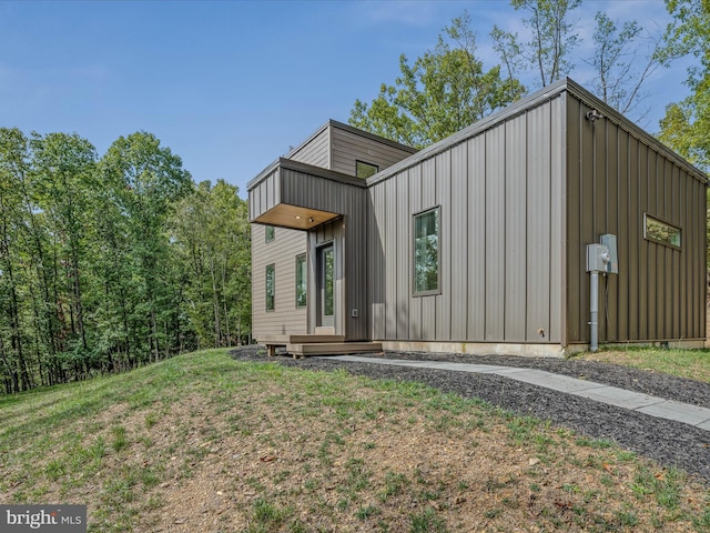 view of home's exterior featuring a lawn and board and batten siding