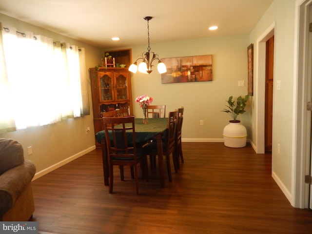 dining space with recessed lighting, baseboards, dark wood-style flooring, and a chandelier