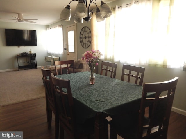 dining area with a ceiling fan, baseboards, and wood finished floors