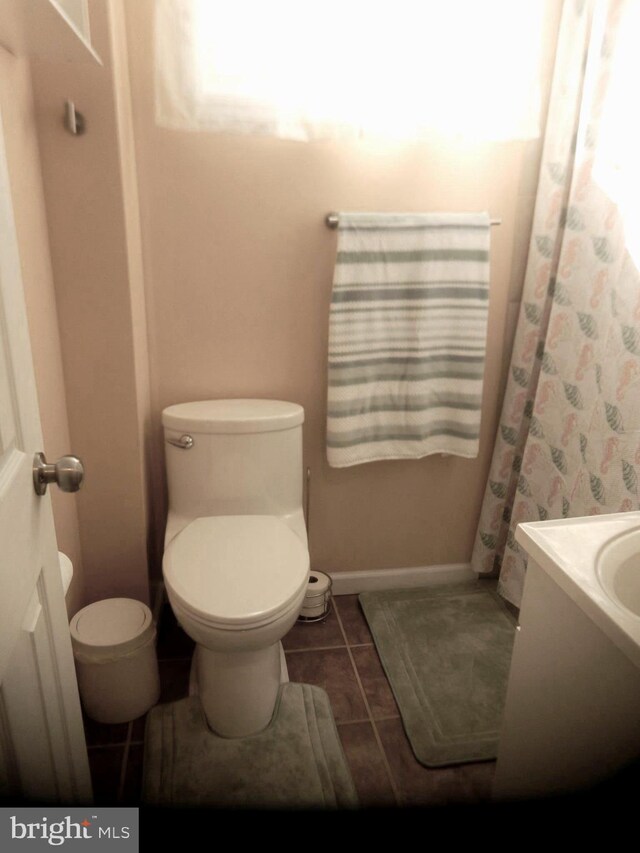 bathroom with vanity, tile patterned floors, toilet, and baseboards