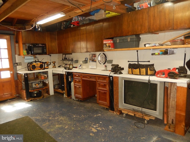 kitchen featuring light countertops and unfinished concrete floors
