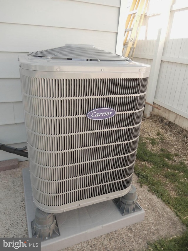 details featuring central air condition unit and fence