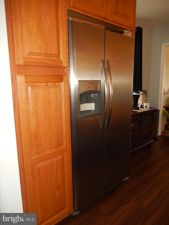 kitchen with stainless steel fridge and dark wood-style flooring