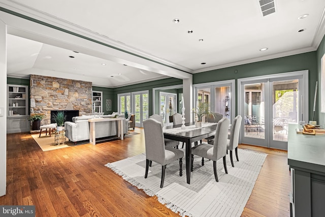 dining room with plenty of natural light, french doors, visible vents, and ornamental molding