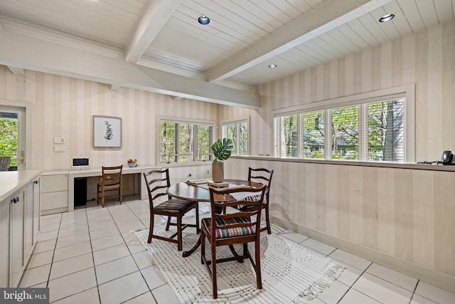 dining area with a healthy amount of sunlight, wallpapered walls, beamed ceiling, and light tile patterned floors