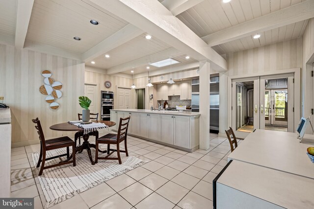 kitchen featuring french doors, beamed ceiling, and light countertops