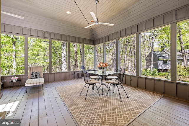 sunroom / solarium featuring a healthy amount of sunlight, outdoor dining space, and a ceiling fan