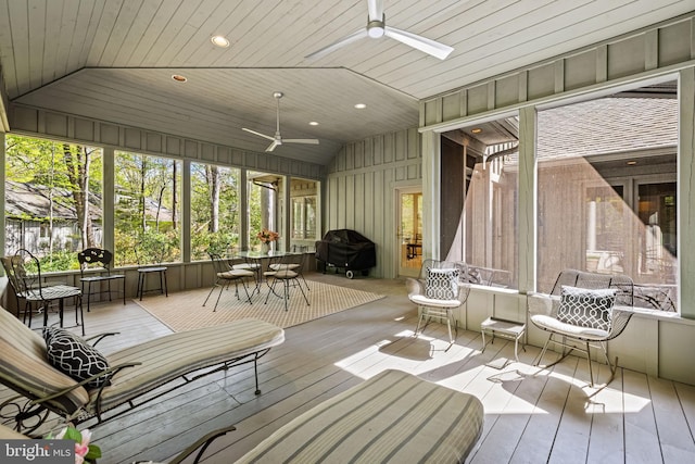 sunroom with a ceiling fan and outdoor dining space
