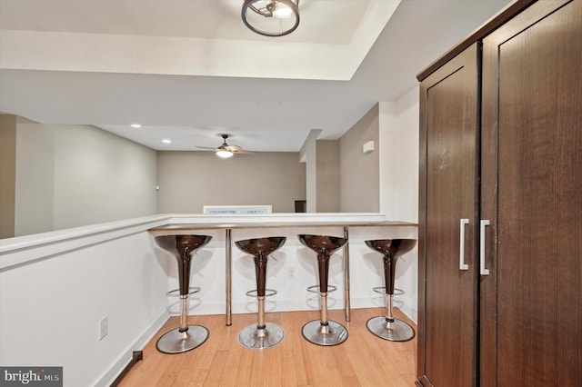 interior space featuring baseboards, light wood-type flooring, and a ceiling fan